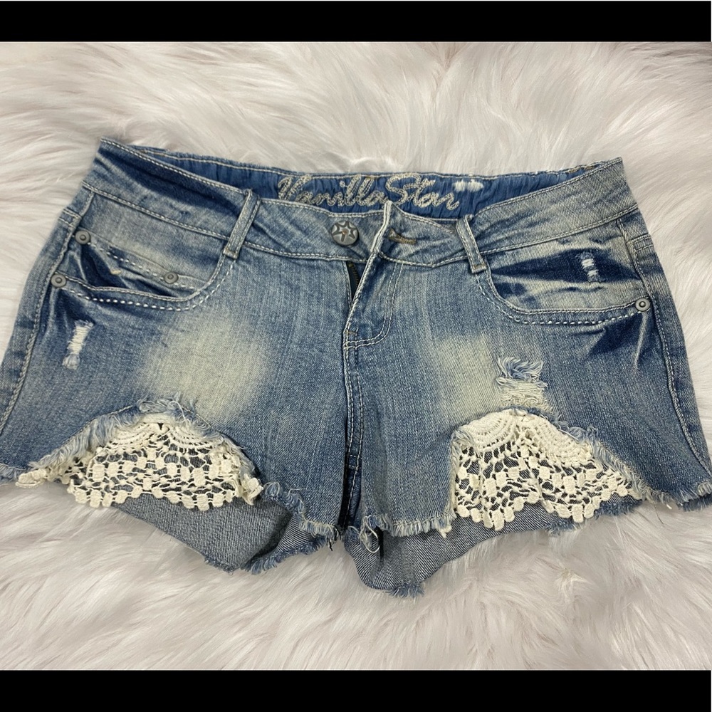 Distressed denim shorts with lace detail on thighs